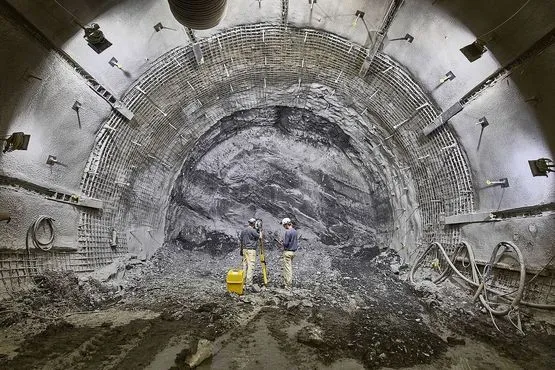 Two surveyors measure a route in the Konrad mine