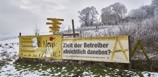 A snowy landscape with two large posters of the citizens' initiatives. Link to page "Actors and tasks"